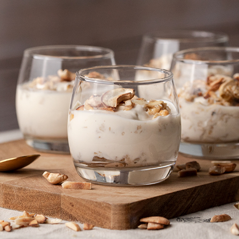 Espresso-Crunch-Dessert: Gläser mit abwechselnden Schichten aus Joghurt und Crunch, garniert mit gerösteten Cashews